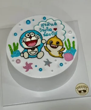 เค้กโดเรมอนและเพื่อนในธีมทะเล พร้อมตกแต่งด้วยสีสันสดใสและตัวการ์ตูนที่น่ารัก เหมาะสำหรับงานเฉลิมฉลองและวันพิเศษ.