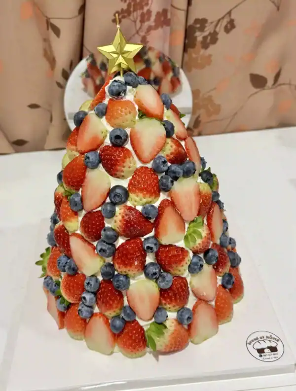 กล่องผลไม้และเค้กผลไม้ตกแต่งสำหรับงานปาร์ตี้คริสต์มาส, เค้กผลไม้สดบนโทนสีแดงและน้ำเงิน, สร้างสรรค์ด้วยผลไม้สดและตกแต่งด้วยดาวทอง, เค้กผลไม้สดสำหรับโอกาสพิเศษ, การตกแต่งเค้กผลไม้สดด้วยสตรอเบอร์รี่, บลูเบอร์รี่และผลไม้อื่น ๆ เพื่อความสวยงามและรสชาติอร่อย.